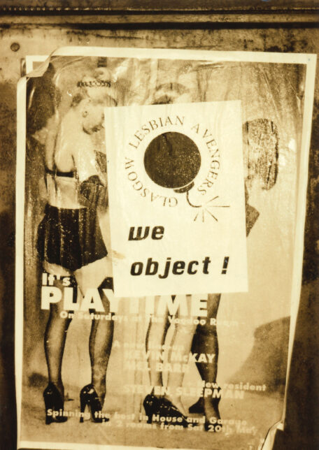 A sepia photograph of a poster of women in underwear. In the centre of the poster is a Lesbian Avengers poster with the text 'We Object', partially covering the women.