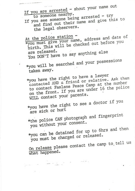 Black and white photocopied flyer with multiple lines of text. It has underlined headings 'If you are arrested', 'At the police station' and 'On release'.