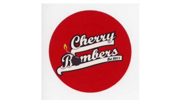 Round sticker with red background: Cherry Bombers of Auld Reekie Roller Derby.