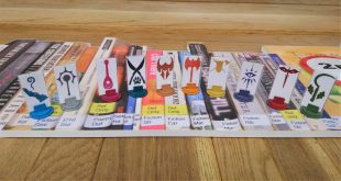 6 dnd character markers sit on top of a photograph of book spines