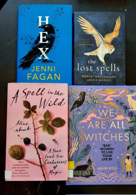 Four books lie on a black background: Hex by Jenni Fagan, The lost spells by Robert MacFarlane and Jackie Morris, A spell in the wild by Alice Tarbuck and We are all witches by Mairi Kidd