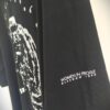 Detail of the Women in Profile logo t-shirt sleeve, with the words 'Women in Profile / Glasgow 1990'