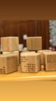Several cubes of wood with words engraved on them sit on top of a wooden shelf in the library