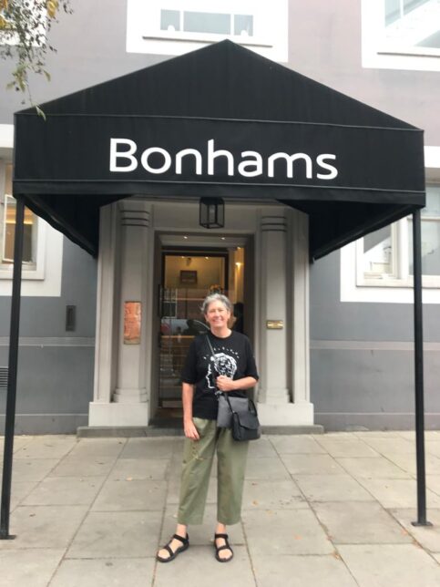 Sue John stands outside the entrance of Bonhams auction house in London