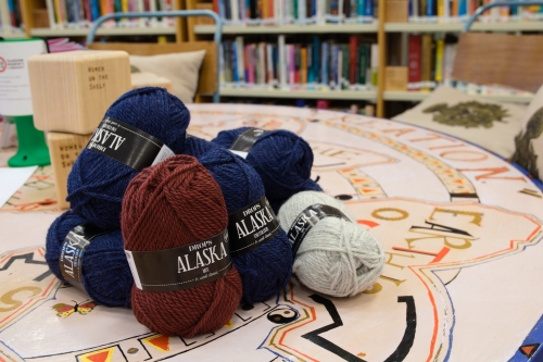 Balls of unknit yarn sat on a the central table at Glasgow Women's Library.