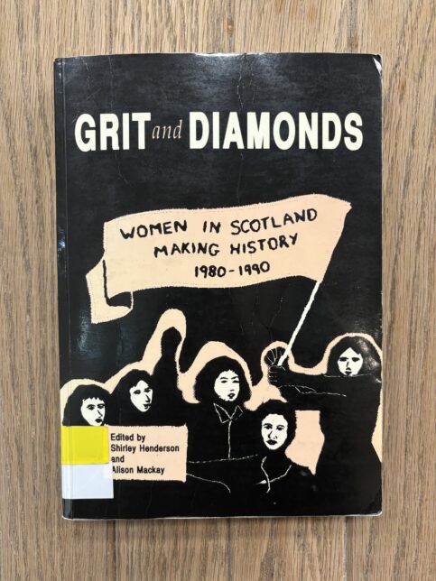 Photo of the book 'Grit and Diamonds' placed on a wooden table.