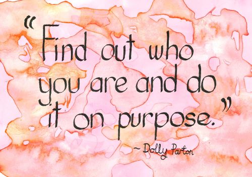Handwritten text reading "Find out who you are and do it on purpose." ~ Dolly Parton' in black ink on  a pink and orange background.