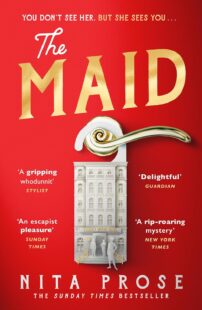 Red book cover depicting a hotel door hanger in the shape of a hotel. Text reads 'The Maid''Nita Prose''The Sunday Times Bestseller''You don't see her - but she sees you'
