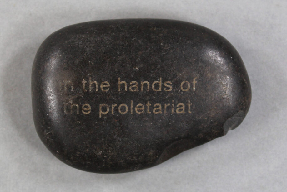 A black stone carved with the words "in the hands of the proletariat"