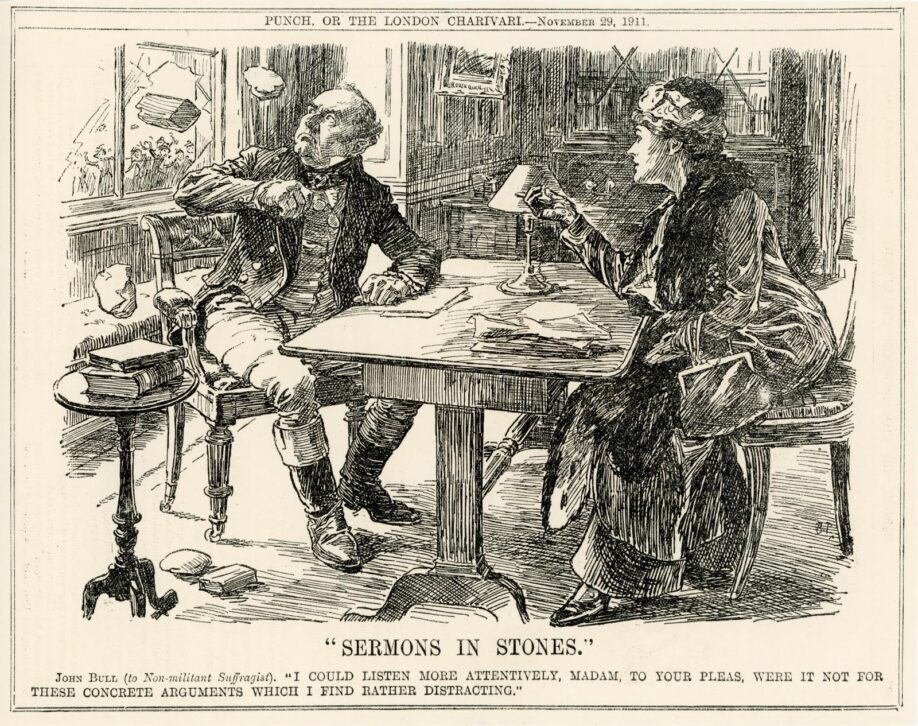 Illustation depicting a man turning away, startled, from a woman seated at a desk as a brick is hurled through the window, captioned: 'John Bull (to Non-militant Suffragist): "I could listen more attentively, Madam, to your pleas, were it not for these concrete arguments which I find rather distracting." '