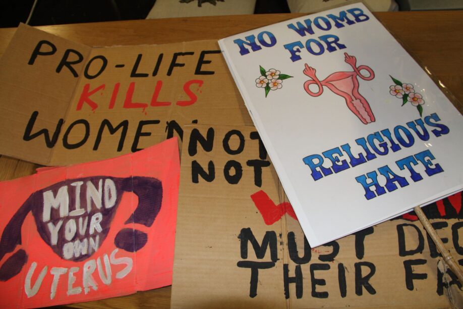 different placards for abortion rights distributed on a table