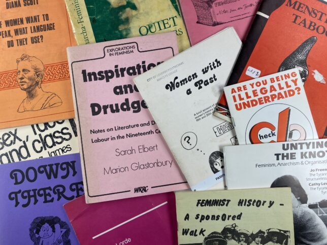 Various pamphlets on women's issues from the GWL archive are laid out on a flat surface