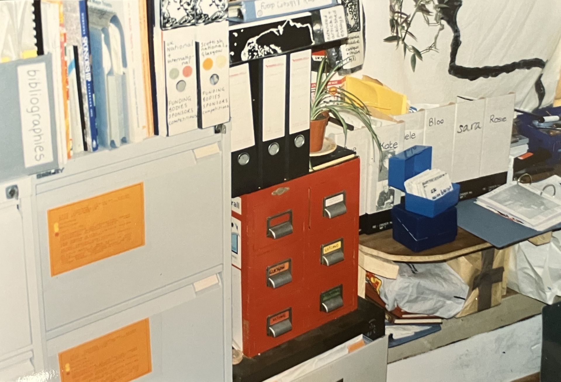 A vintage photo from the early days of GWL, showing crowded files in an office space