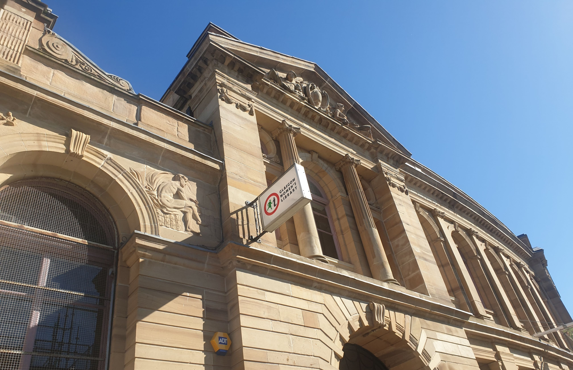 GWL's building in Landressy Street, bright sunlight making the blond sandstone walls and columns glow