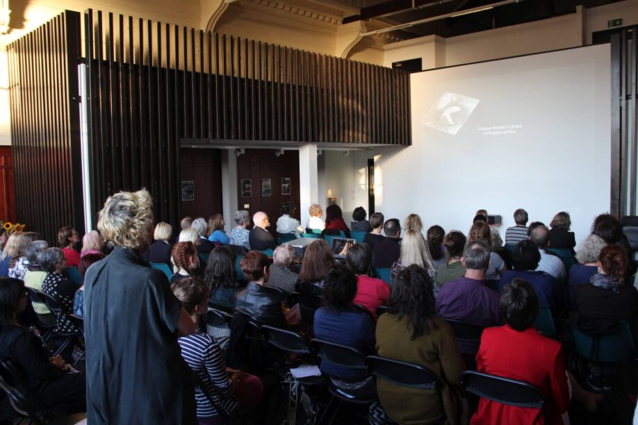 An audience watches a film in our main event space.