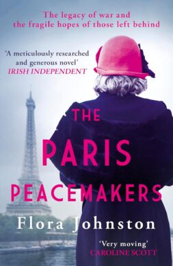 Cover of the Paris Peacemakers with a woman standing with her back to the camera, wearing a pink bucket hat and a long purple coat, with the Eiffel tower in the distance.