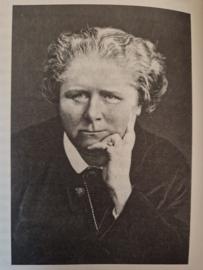 Black and white photograph of Frances Power Cobbe. Resting her chin on her hand. 