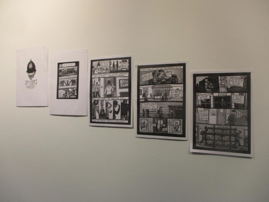 
A wall with four black and white posters printed from the graphic novel ‘Spycops: An introduction & historical context’ by Glen Hustler. 
