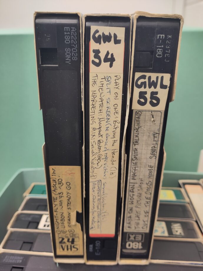 Three numbered VHS tapes from the lending collection with handwritten labels showing the programmes taped from television